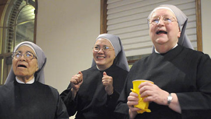 Sister Monique, left, Sister Rosemary, center, and Mother Mary Vincent watch a play unfold during the first half of the Super Bowl at the Little Sisters of the Poor senior care facility on the North Side last night.