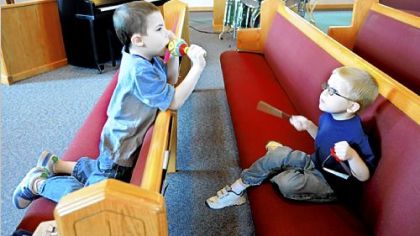 Henry Cicconi, 7, shakes a maraca while his brother Gus, 5, plays a triangle during the Sunday service at Our Redeemer Lutheran Church in Peters aimed at children with autism. Both boys are from Canonsburg.