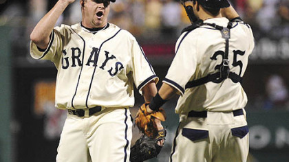 Pirate pitcher Matt capps celebrates his 17th save with catcher Jason Jaramillo, right.