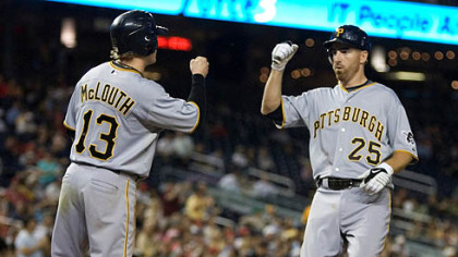 Adam LaRoche is congratulated by teammate Nate McLouth after he homered, scoring McLouth, during the seventh inning of  last night's game against the Nationals in Washington.