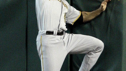 Pirates right fielder Garrett Jones leaps as he tries to catch a two-run triple hit by Astros third baseman Geoff Blum during the first inning of last night's game. Astros shortstop Miguel Tejada and first baseman Lance Berkman scored on Blum's triple.