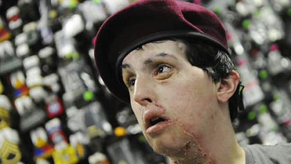 Kevin tries on a maroon beret from his unit. He was a member of the 173rd Airborne Brigade.