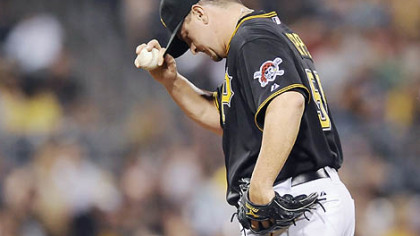The Pirates' Matt Capps hangs his head after giving up a two-run homer to the Rockies' Brad Hawpe in the ninth inning.