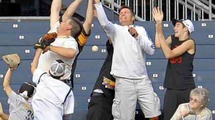 Pirates fans try to grab a home run hit by third baseman Andy LaRoche in the second inning.