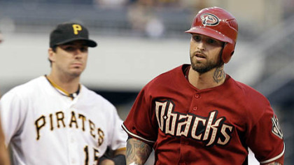 Diamondbacks infielder Ryan Roberts rounds third past Pirates third baseman Andy LaRoche after hitting a two-run home run off Pirates pitcher Zach Duke.