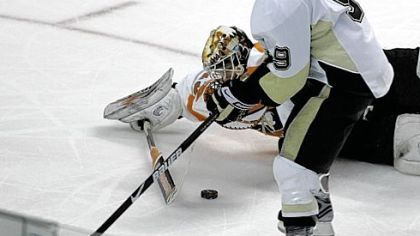 Flyers goalie Martin Biron, right, loses control of the puck well away from the net, allowing Pascal Dupuis to feed it over to Sidney Crosby for what proved to be the winning goal.