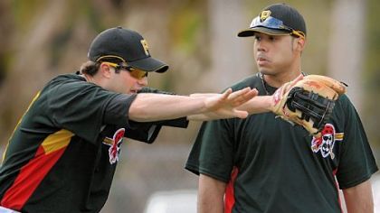 Former No. 1 Pirates prospect Neil Walker, left, talks with current No. 1 prospect Pedro Alvarez during drills at third base in February in Bradenton, Fla.