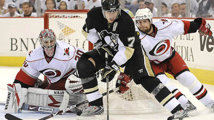 Evgeni Malkin prepares to backhand the puck past Hurricanes goalie Cam Ward in the third period last night for his third goal of the game.