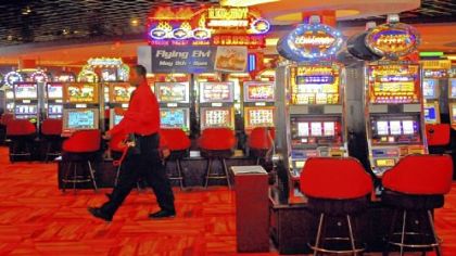 Workers at the permanent Meadows Casino move about the 3,200-plus video slot machines before opening the doors for a test outing for charity Monday.