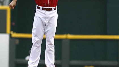 Reds second baseman Drew Sutton goes up for the throw as Pirates outfielder Garrett Jones slides safely stealing second base in the third inning of the first game.