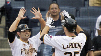 Pirates first baseman Adam LaRoche (25) is greeted by second baseman Freddy Sanchez, who scored on LaRoche's ninth-inning home run off Mets pitcher Francisco Rodriguez yesterday.