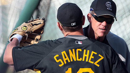 Pirates second baseman Freddy Sanchez, hugs Rockies manager and former Pirates manager Jim Tracy before last night's game.