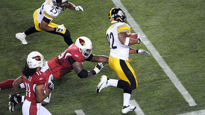 James Harrison returns an interception 100 yards for a touchdown at the end of the first half Sunday in Super Bowl XLIII.