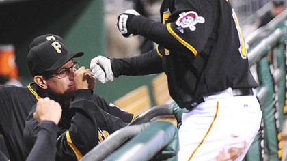 Nate McLouth high-fives manager John Russell after McLouth's two-run home run against the Atlanta Braves in the eighth inning.