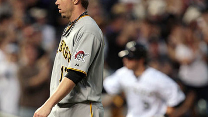 Relief pitcher Sean Burnett, foreground, reacts after giving up a two-run home run to Colorado Rockies' Ian Stewart, background, in the sixth inning of last night's baseball game in Denver.