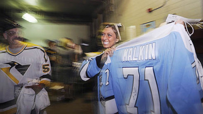 Taylor Dettore, a senior at Neshannock High School, shows off the autographed Evgeni Malkin jersey she received at last night's Penguins playoff game at Mellon Arena.