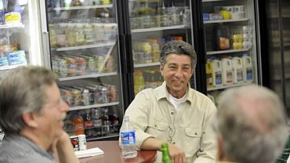 Co-owner John Prodan chats with customers inside the Frick Park Market in Point Breeze on a recent Friday.