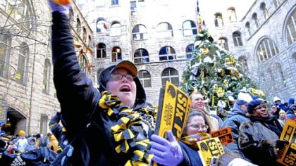 Josalyn Davis, from Rochester, Pa. cheers along at the Roast Ravens Rally held around the Terrible Tree in the courtyard of the Allegheny County Courthouse on Friday.