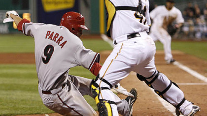 Pirates catcher Ryan Doumit reaches for the throw as Diamondbacks outfielder Garardo Parra scores one of the Diamondbacks five runs in the 12th inning.