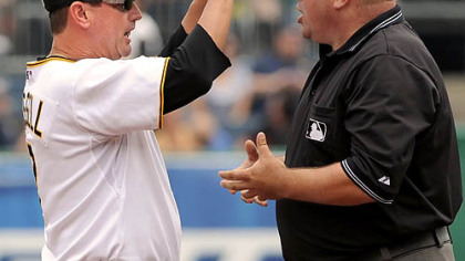 Pirates manager John Russell argues a call made by first base umpire Marty Foster.