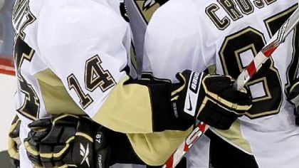 Pittsburgh Penguins' Chris Kunitz, left, and Sidney Crosby, right, celebrate an empty-net goal by Jordan Staal, center, against the Boston Bruins in the third period of an NHL hockey game in Pittsburgh Sunday, March 15, 2009. The Penguins won 6-4 with Kunitz getting a hat trick.