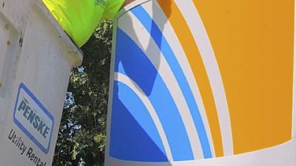 Alex Aversa, of McKees Rocks, works on one of two signs changed to convert the old National City Bank, at the corner of Ingomar Road and Harmony Drive in McCandless, to the First Niagara name.