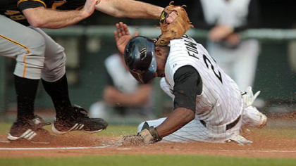 Pirates pitcher Ross Ohlendorf applies a late tag as the Rockies' Dexter Fowler scores on a passed ball in the first inning.