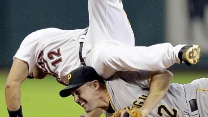 Houston's Ivan Rodriguez falls onto Jack Wilson after Wilson dove to second base to record the force of Rodriguez in the eighth inning as the Astros tried to rally last night in Houston.