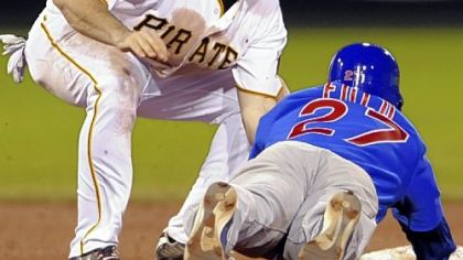 Pirates shortstop Jack Wilson tags out Cubs outfielder Sam Fuld at second base on a steal attempt in the eighth inning last night.
