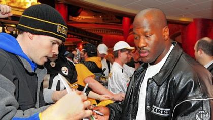 Fans line up inside the AMC Loews Waterfront 22 cinema in West Homestead as linebacker James Harrison signs autographs before the debut of the NFL Films DVD documenting the Steelers' season.