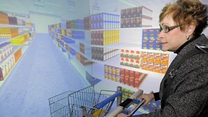 Paula Calabrese scans the shelves to identify products called to her as she strolls a virtual reality grocery store at UPMC Eye and Ear Hospital as part of a study on why some people have balance problems in certain environments, such as the aisles of stores. The subject walks on a treadmill and guides the cart thorough imagery adapted from a video game.