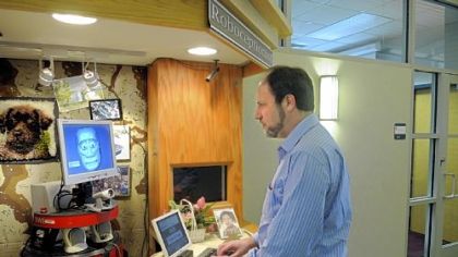 "Tank" (left)  the roboceptionist at Newell-Simon Hall  on the CMU campus communicates via keyboard with Reid Simmons (right) a research professor in robotics.