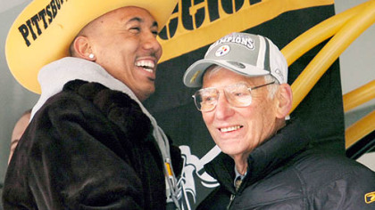 Hines Ward greets team owner Dan Rooney on the stage during a parade for the Super Bowl XL champion Pittsburgh Steelers in 2006.