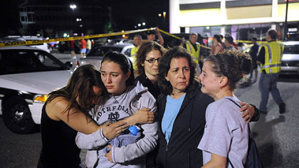 Tracey Smith, 22, second from left, who was inside LA Fitness at the time of last night's shooting, receives a hug from her sister, Theresa, while their mother, Nancy, comforts friend Jill Mazur, 22, in Collier last night. Behind them is friend Ashley Slifko, 19.