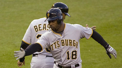 Craig Monroe celebrates with third base coach Tony Beasley after hitting a three-run home run against the Nationals in the third inning last night in Washington.