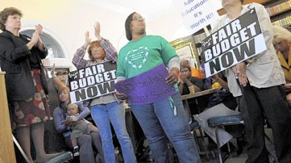 From left, Dianne Gallagher, of the Center for Hearing & Deaf Services, Deborah McNier, 44, of the North Side, Adrienne Roberts, 39, of McKees Rocks, and Susan Cooper, 58, of Lawrenceville, show their support yesterday during a news conference at the Focus on Renewal community center in McKees Rocks.