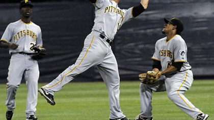Pirates second baseman Freddy Sanchez, center, catches a shallow pop fly off the bat of Twins infielder Brendan Harris under the watch of center fielder Andrew McCutchen, left, and right fielder Delwyn Young, right, in the first inning last night's game.