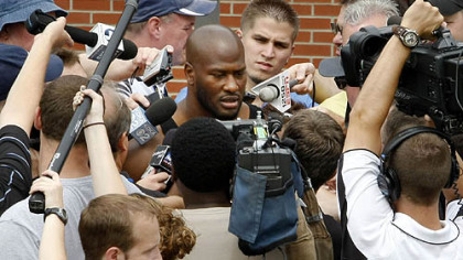 Steelers linebacker James Harrison is mobbed by cameras as he talks with reporters on his arrival at training camp.