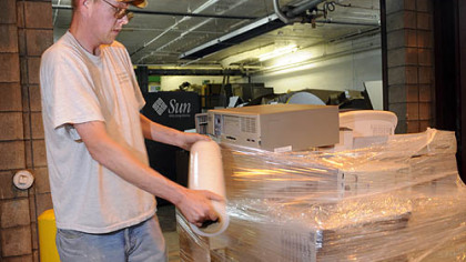 Paul Vareberg, foreman with  A. Greenspan Computer Recycling in Turtle Creek,  wraps computers for  shipment to Canada