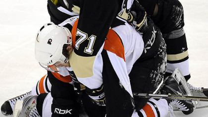 Evgeni Malkin gets tied up with Flyers' Ryan Parent in the first period.