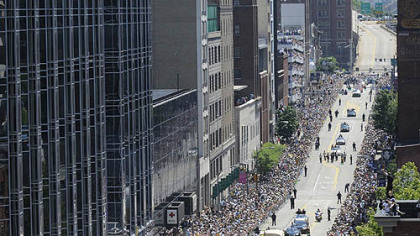 Fans line the Boulevard of the Allies, Downtown, for yesterday's parade.