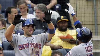Mets first baseman Fernando Tatis, right, crosses home plate to greetings from third baseman David Wright (5), who scored on Tatis' two-run home run in the sixth inning off Pirates pitcher Jeff Karstens yesterday.