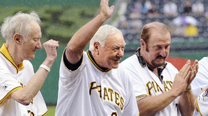 Pirates hall-of-famer Bill Mazeroski waves to the crowd after being introduced during a ceremony honoring the 100th anniversary of Forbes Field last night. Mazeroski is flanked by Nellie King, left, and Bob Robertson.