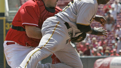 Reds catcher Corky Miller tags out Pirates outfielder Lastings Milledge at home in the fourth inning during yesterday's game in Cincinnati.