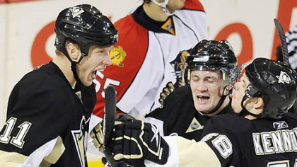Jordan Staal (11) celebrates his third-period goal with Matt Cooke and Tyler Kennedy last night at Mellon Arena.