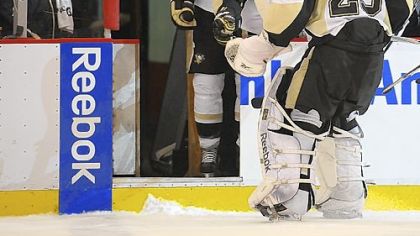Marc-Andre Fleury makes his way to the bench after being pulled late in the second period with the Penguins down, 5-0.