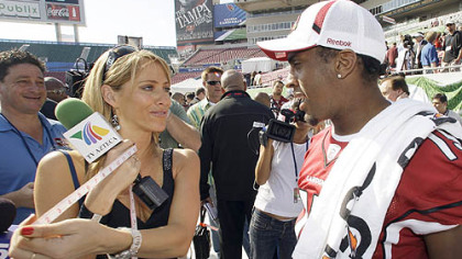 TV Azteca reporter Ines Sainz measures the biceps of Cardinals receiver Steve Breaston, a Woodland Hills High School graduate appearing in his first Super Bowl.