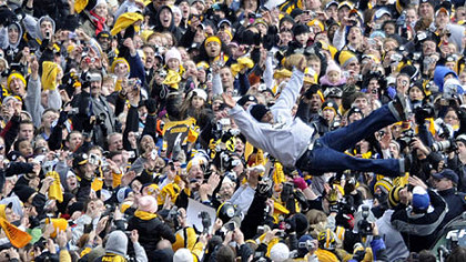 Steelers' safety Ryan Clark leaps from his vehicle into the waiting arms of Steelers fans lining the Boulevard of the Allies.