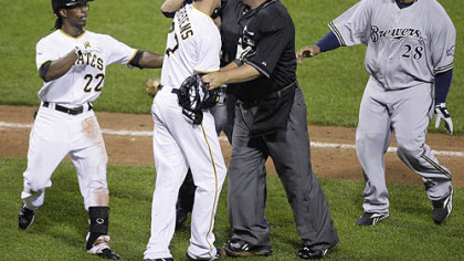 Pirates pitcher Jeff Karstens is stopped by umpire Chad Fairchild and Brewers catcher Jason Kendall, rear center, from getting to Brewers pitcher Chris Smith after being hit by a pitch in the eighth inning. At left is Pirates outfielder Andrew McCutchen and at right is Brewers first baseman Prince Fielder.