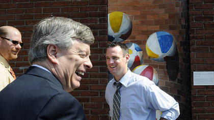Michael Glasser, chairman of the Oakland Business Improvement District, far left, University of Pittsburgh Chancellor Mark A. Nordenberg and Pittsburgh Mayor Luke Ravenstahl, right, pause near the Doors of Oakland public art project during the mayor's G-20 sweep in that city neighborhood yesterday. It was the fourth of five planned sweeps the city has undertaken as part of its cleanup efforts in advance of next month's international summit.